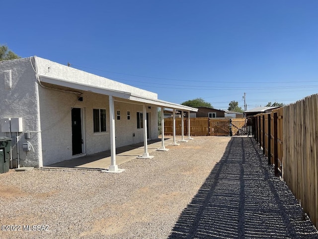 exterior space featuring a patio, a fenced backyard, and stucco siding