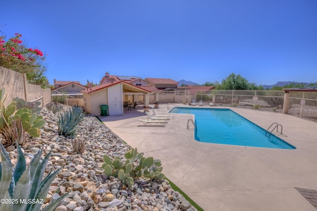 view of pool with a fenced backyard, a fenced in pool, and a patio