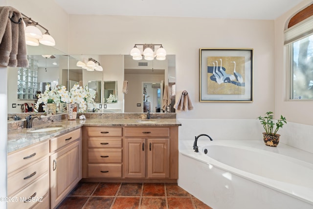 full bath with a sink, visible vents, a garden tub, and double vanity