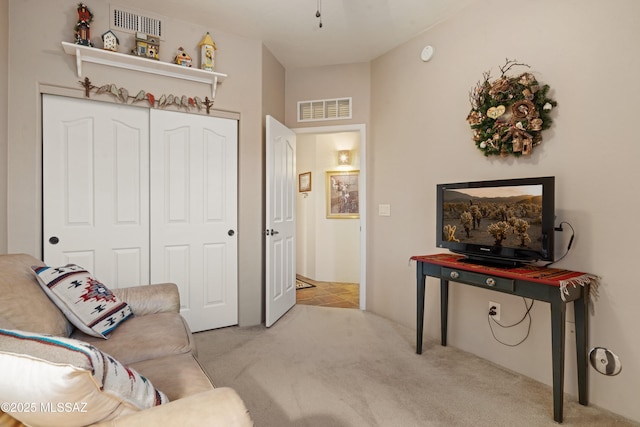 living area with visible vents and carpet floors