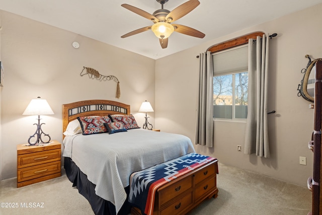 bedroom featuring light carpet and a ceiling fan