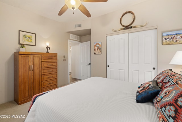 bedroom featuring visible vents, light carpet, a closet, and ceiling fan