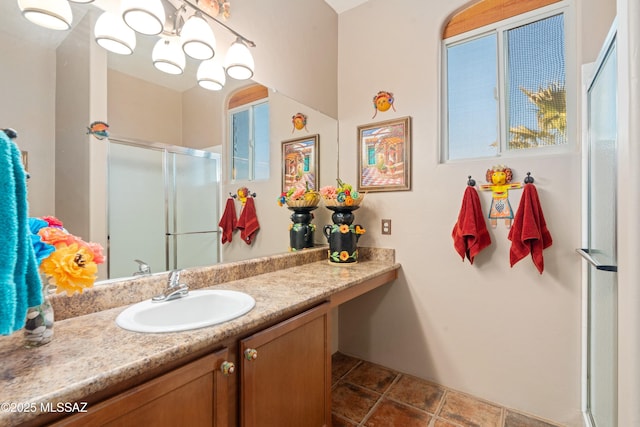 full bathroom with vanity, tile patterned floors, and a stall shower