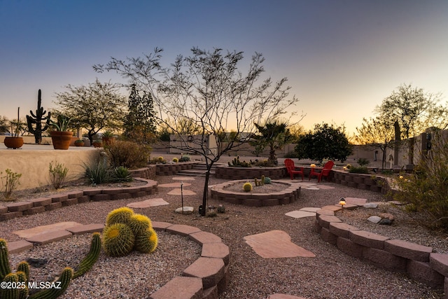 yard at dusk with a patio and fence