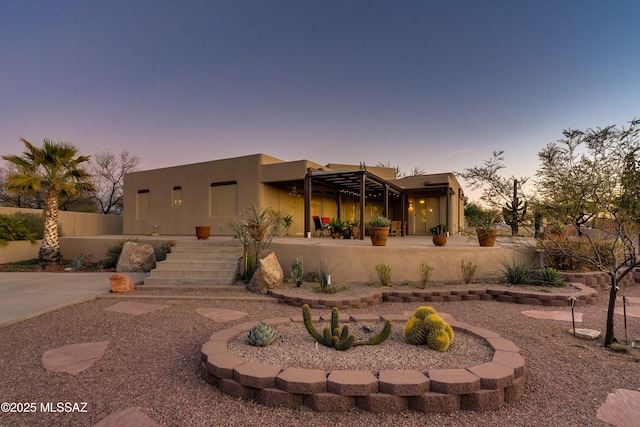 rear view of house featuring fence