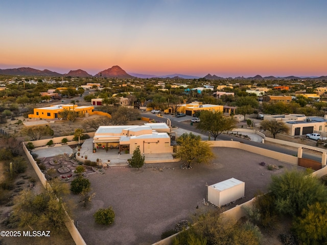 aerial view at dusk featuring a mountain view