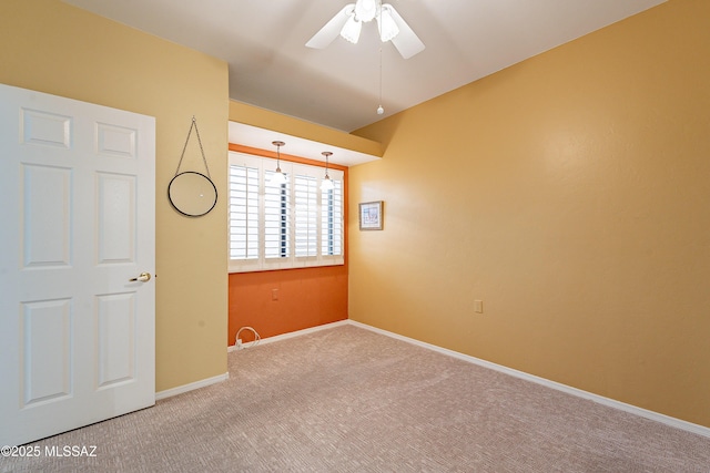 empty room with a ceiling fan, baseboards, and carpet flooring