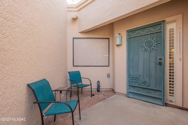 property entrance featuring a patio area and stucco siding