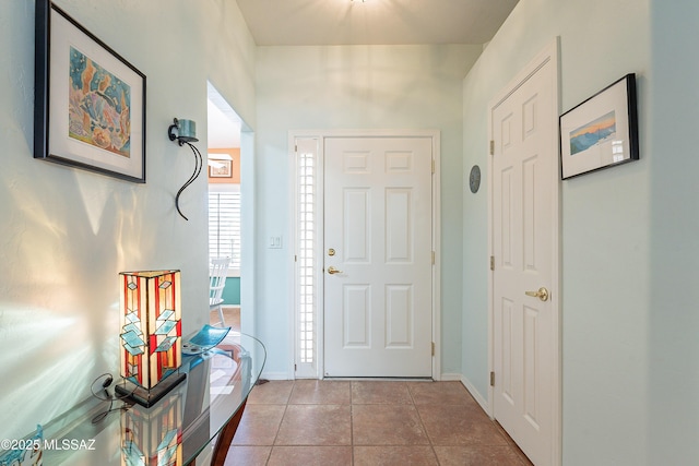 foyer featuring tile patterned flooring and baseboards