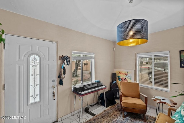 foyer entrance featuring a healthy amount of sunlight, baseboards, and tile patterned floors