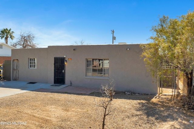 southwest-style home featuring stucco siding and a patio