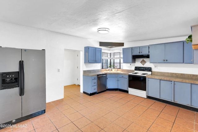 757 W Glenn St, Tucson, AZ 85705 - kitchen with appliances with stainless steel finishes, blue cabinetry, light tile patterned floors, and tile counters