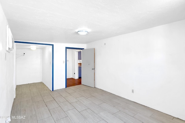 757 W Glenn St, Tucson, AZ 85705 - unfurnished bedroom featuring a closet and a textured ceiling