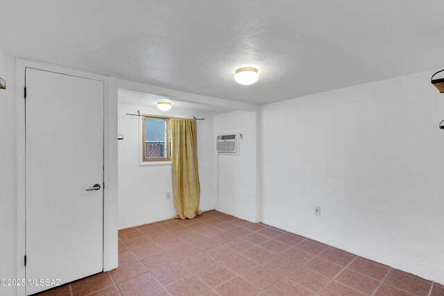 unfurnished room with a wall unit AC