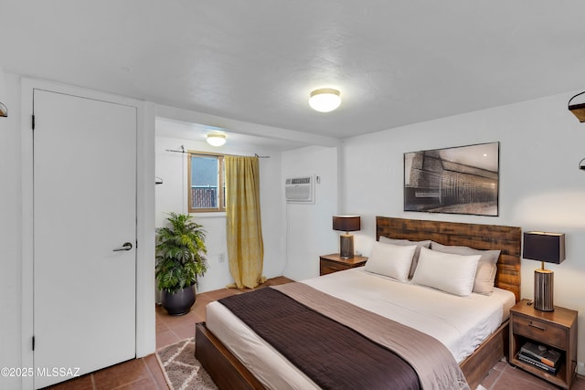 bedroom with tile patterned flooring and a wall mounted air conditioner