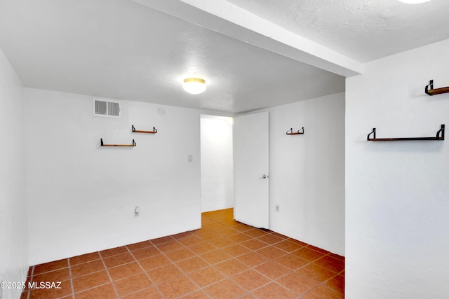 unfurnished room with tile patterned floors and visible vents