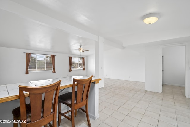 dining area featuring light tile patterned floors and a ceiling fan