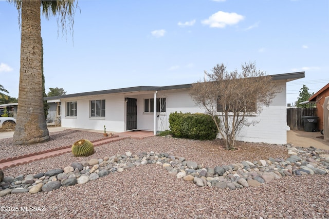 single story home with fence