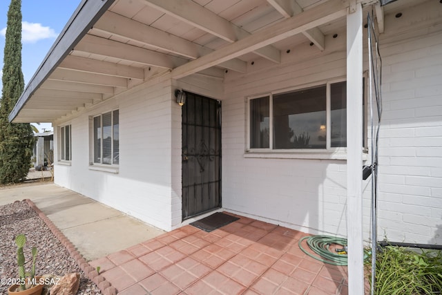 entrance to property with brick siding