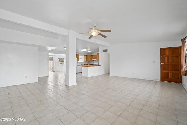 unfurnished living room featuring light tile patterned floors, visible vents, baseboards, vaulted ceiling, and a ceiling fan