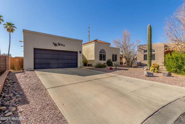 view of front of house with fence and stucco siding