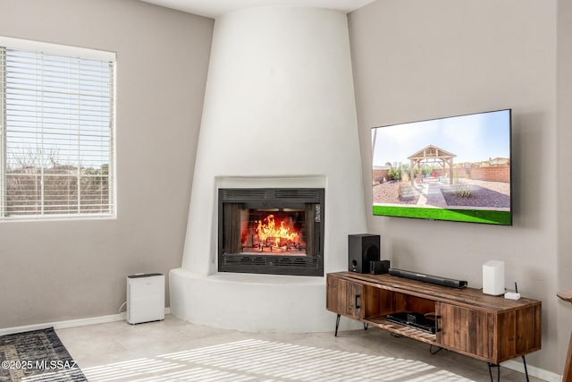 room details featuring a lit fireplace and baseboards