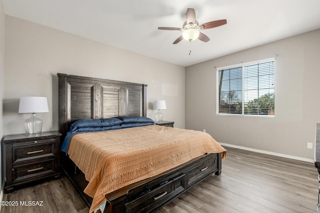 bedroom with dark wood-style flooring, ceiling fan, and baseboards