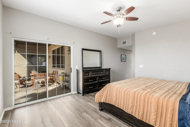 bedroom featuring baseboards, visible vents, a ceiling fan, wood finished floors, and access to exterior