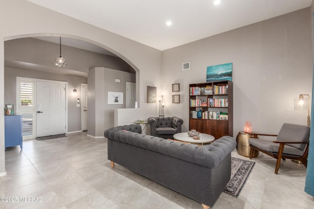 living room with visible vents, arched walkways, baseboards, and recessed lighting