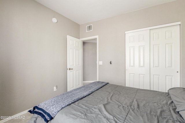 bedroom featuring a closet and visible vents