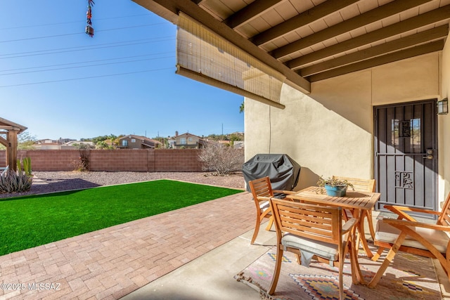 view of patio / terrace with grilling area and fence private yard