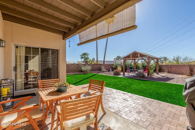 view of patio / terrace with a gazebo, outdoor dining space, and a fenced backyard