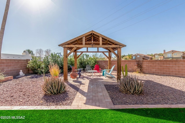 view of patio / terrace featuring a fenced backyard, a fire pit, and a gazebo