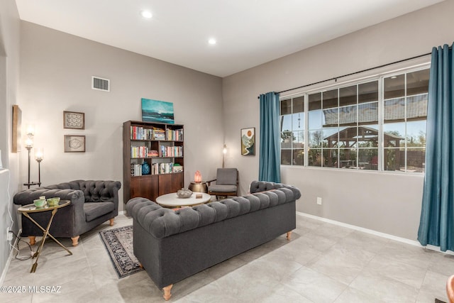 living area with recessed lighting, visible vents, and baseboards