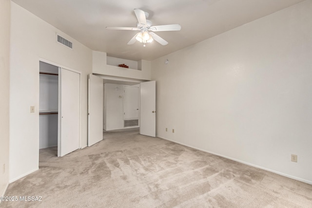 unfurnished bedroom with carpet floors, a closet, visible vents, and ceiling fan