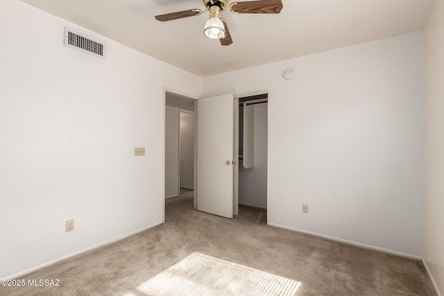 unfurnished bedroom with carpet flooring, a ceiling fan, visible vents, baseboards, and a closet