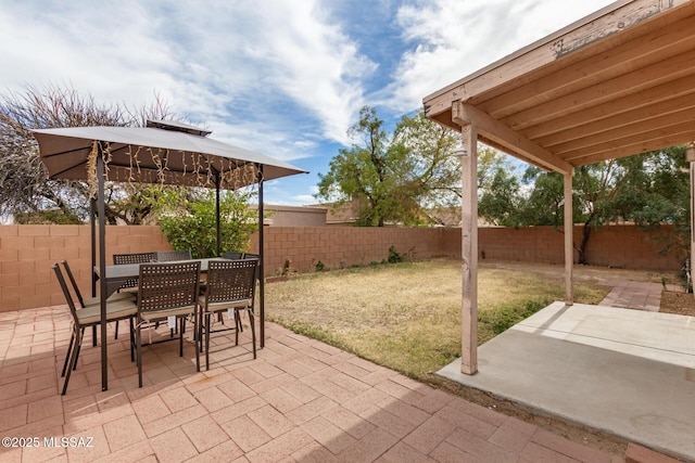 view of patio / terrace featuring outdoor dining space, a fenced backyard, and a gazebo