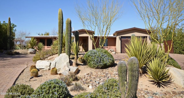 view of front of house featuring a garage and stucco siding