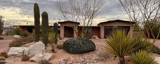 view of front of property featuring a garage and stucco siding