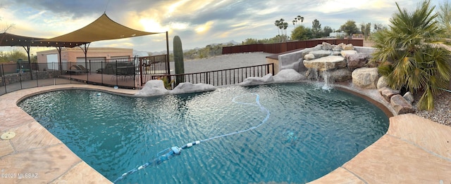 view of swimming pool with a fenced in pool, fence, an outdoor structure, and a jacuzzi