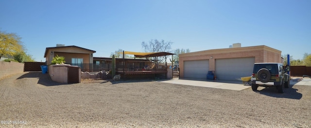 exterior space featuring a garage, an outbuilding, and fence