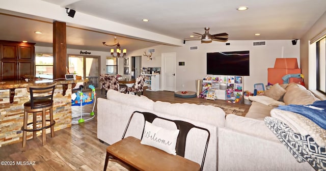 living area with vaulted ceiling with beams, visible vents, wood finished floors, and recessed lighting