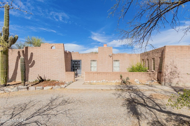 view of front of home featuring a fenced front yard and a gate