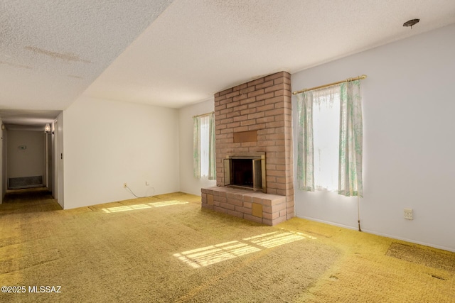 unfurnished living room with carpet, a textured ceiling, and a fireplace