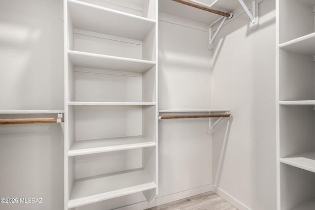 spacious closet with wood finished floors