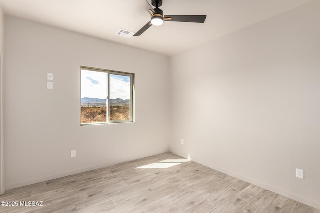 unfurnished room featuring visible vents, ceiling fan, light wood-style flooring, and baseboards