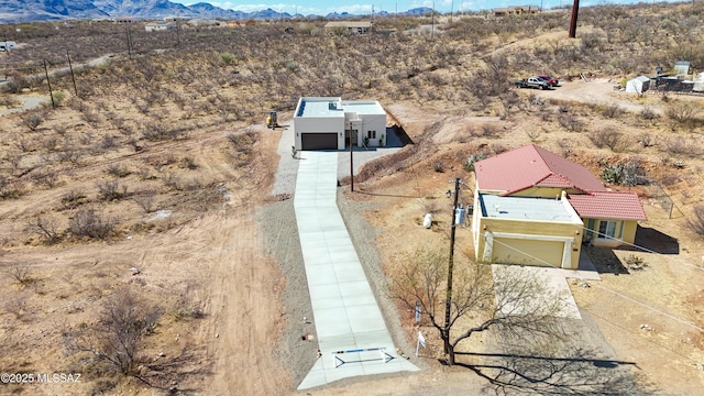 aerial view featuring a mountain view and view of desert