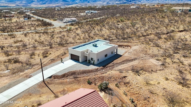 aerial view featuring a desert view and a mountain view