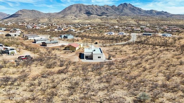 birds eye view of property with a mountain view