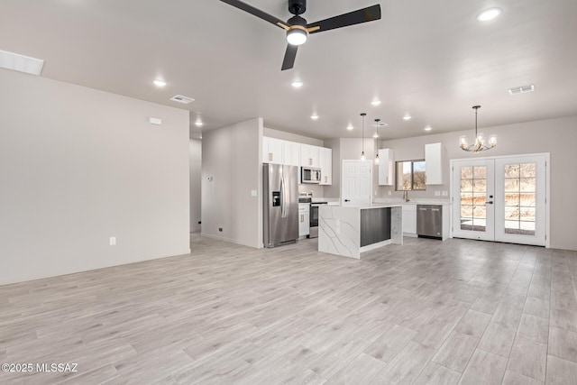 unfurnished living room featuring light wood finished floors, visible vents, and recessed lighting